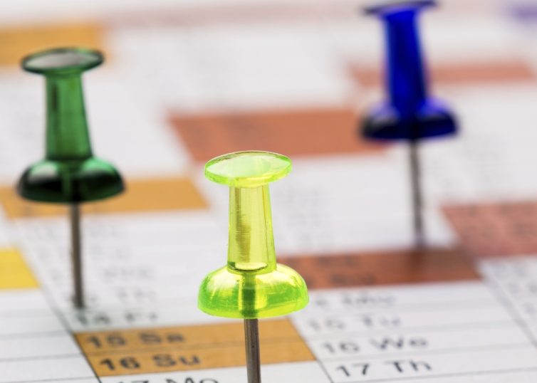 Pushpins on a calendar