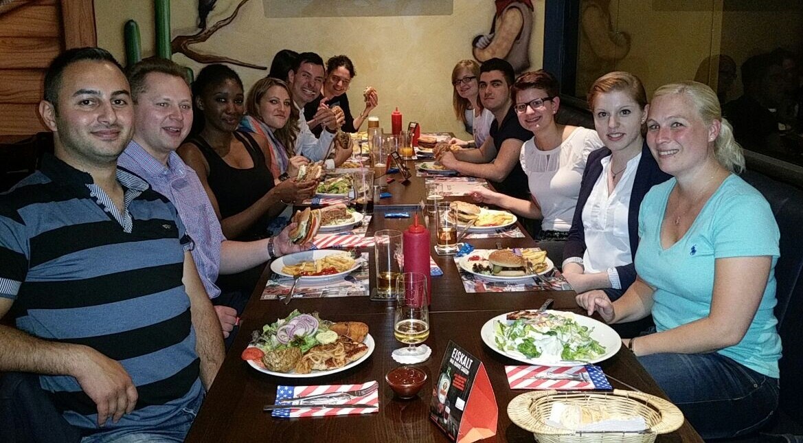 People eating dinner at a long restaurant table