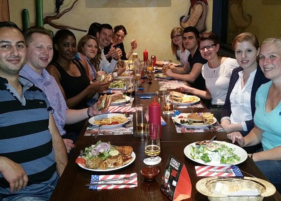 People eating dinner at a long restaurant table