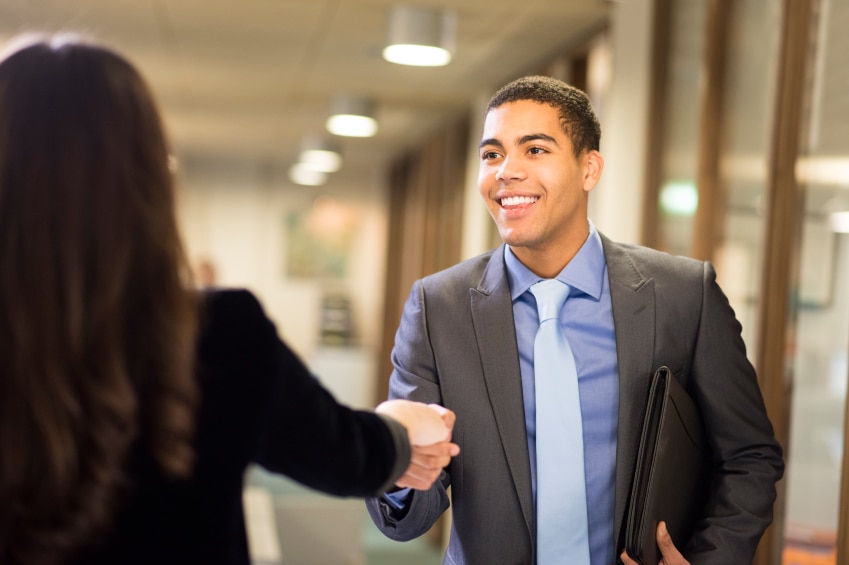 Two people shaking hands after an interview