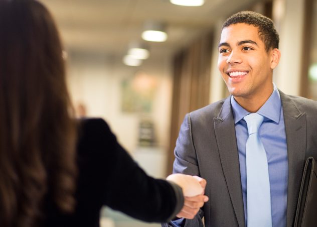 Two people shaking hands after an interview