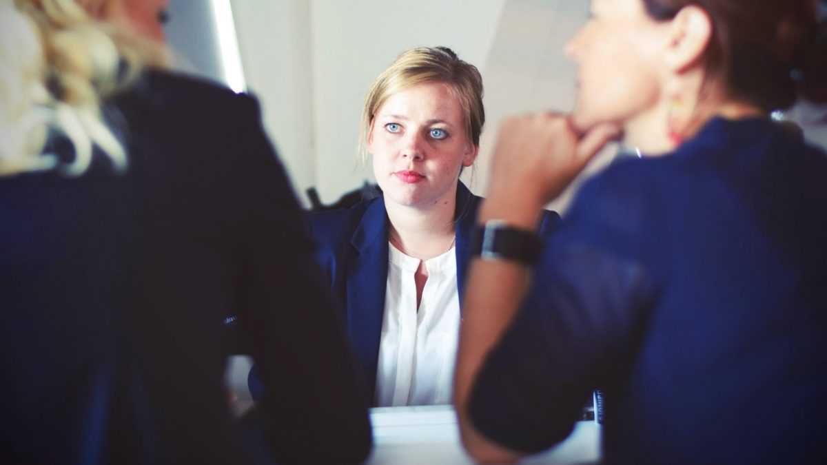 Girl staring at two women talking
