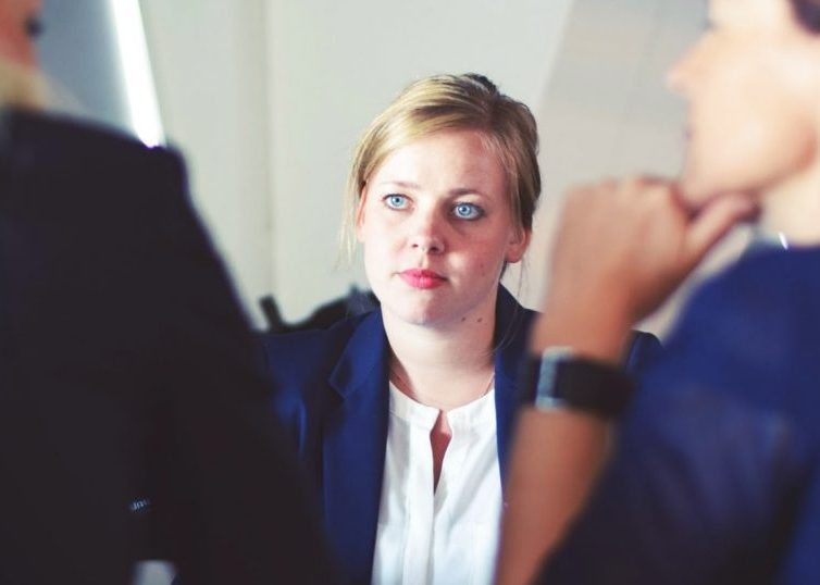 Girl staring at two women talking