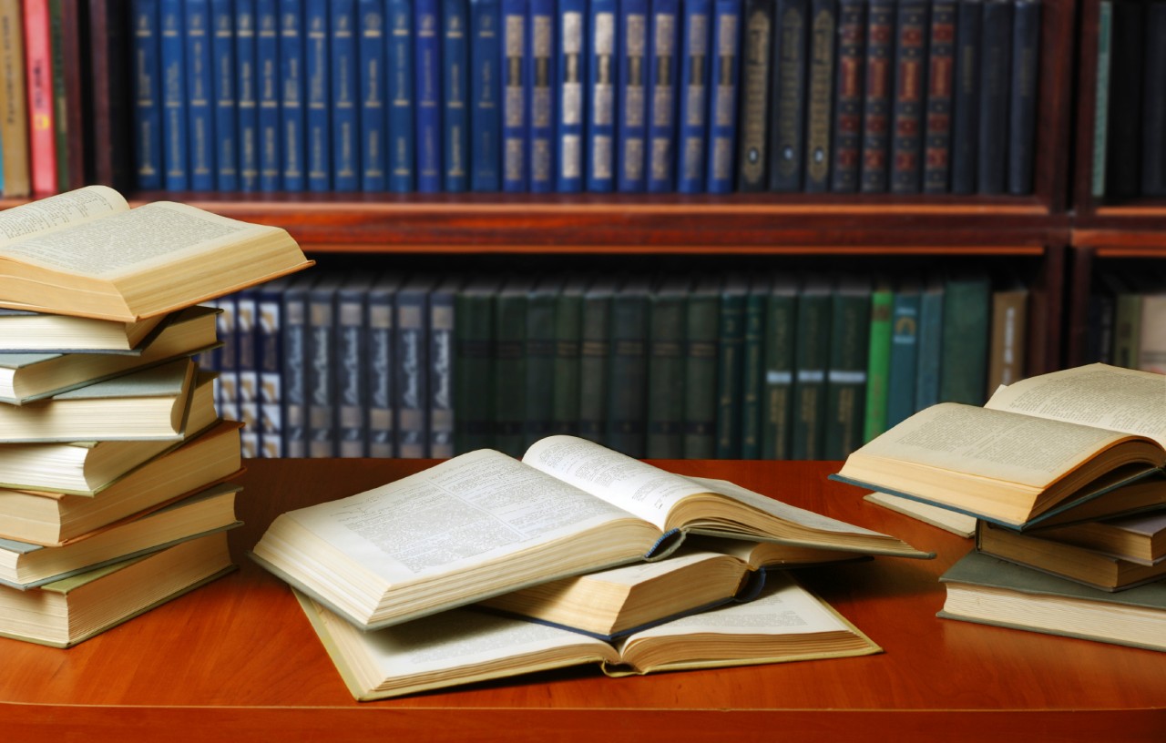 Books open on a desk in a library