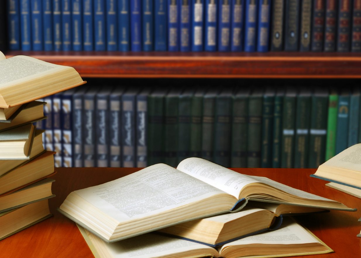 Books open on a desk in a library