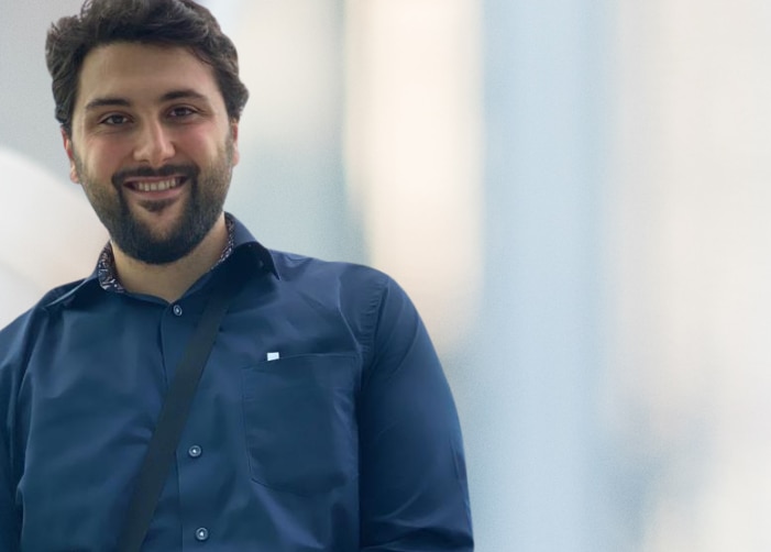 Man in dark blue dress shirt with blurred background