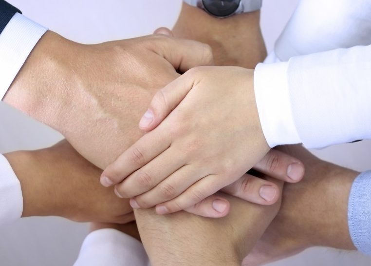 Hands stacked on top of each other