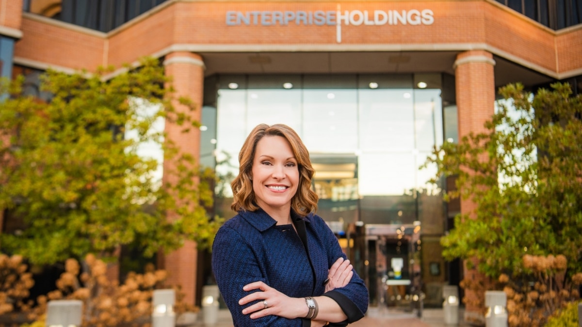 Photo of CEO Chrissy Taylor in front of brick and glass building