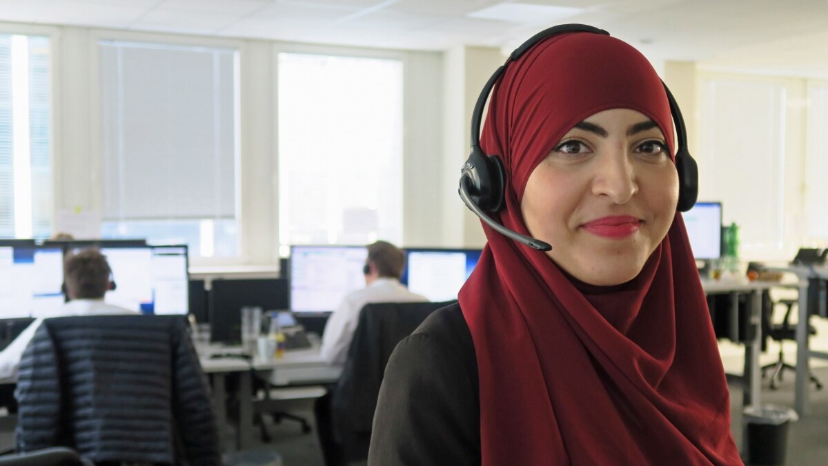 Woman in red headscarf with headset in office