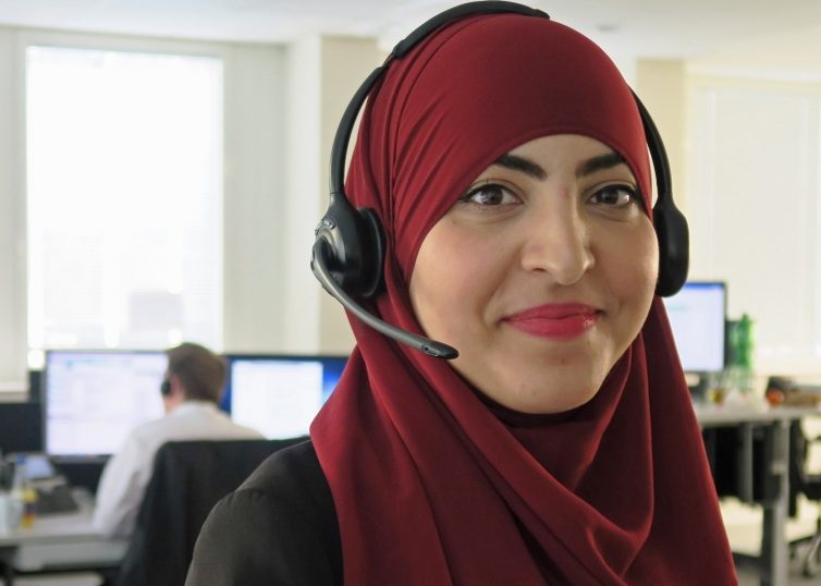 Woman in red headscarf with headset in office