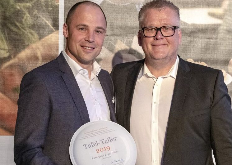 Two men holding an award