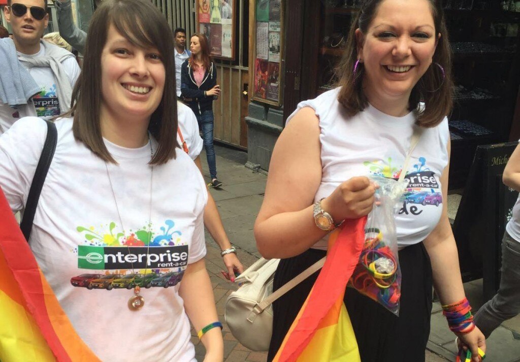Two female Enterprise employees walking in a Pride parade