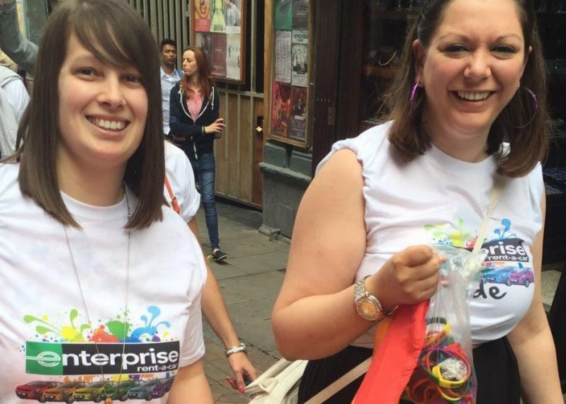 Two female Enterprise employees walking in a Pride parade