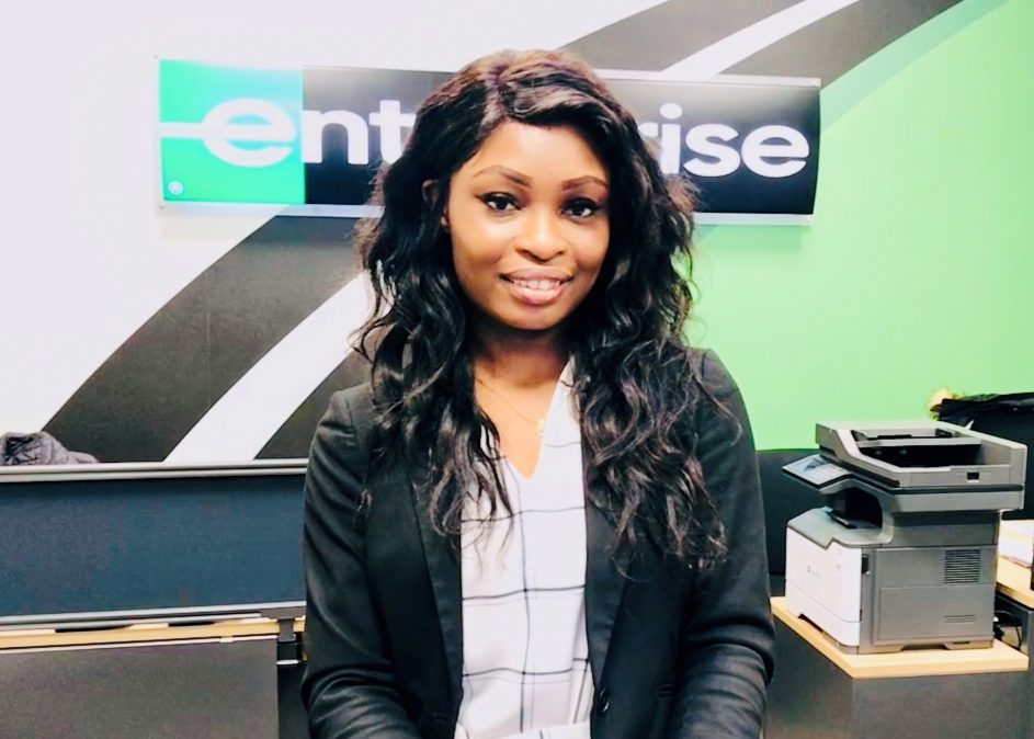 Woman in business clothes in front of Enterprise desk
