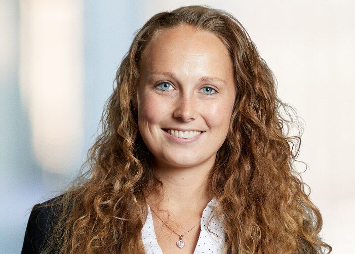 Professional photo of woman with long curly hair in a blazer