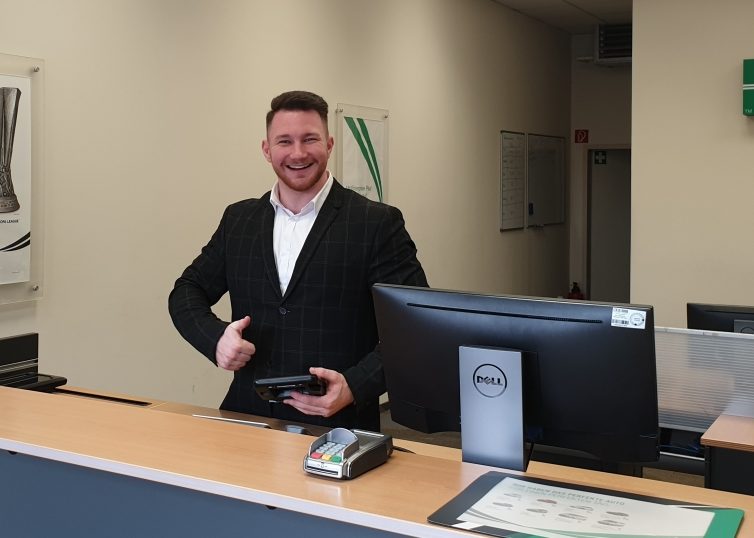 Man behind Enterprise service counter giving a thumbs up