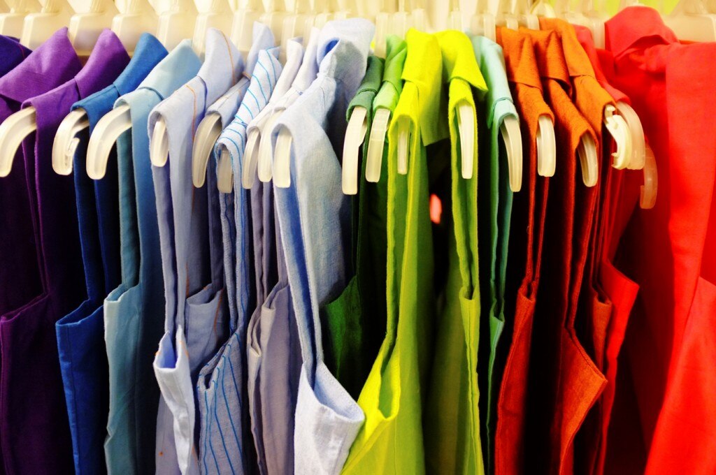 Sleeveless blouses hung in rainbow order
