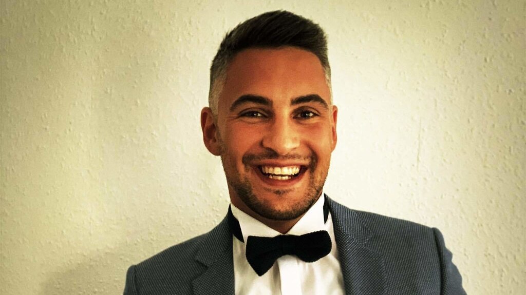 Man smiling in suit with bow tie
