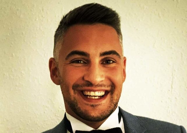 Man smiling in suit with bow tie
