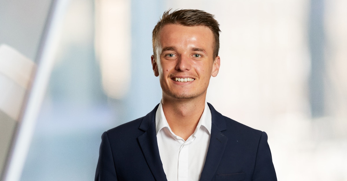 Man in suit smiling with a blurred background