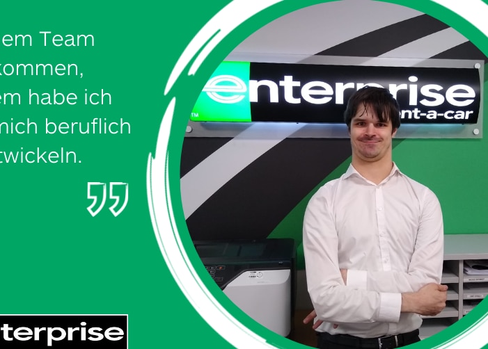 Man in dress shirt with arms crossed in front of Enterprise sign with quote on green background