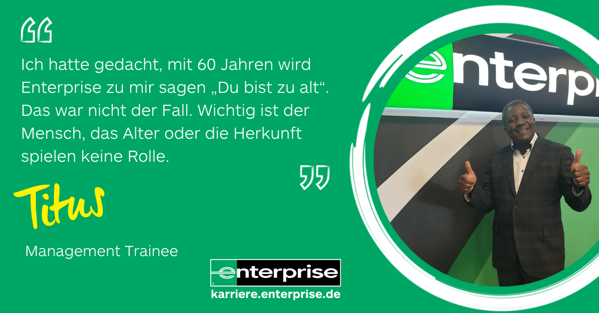 Man in suit giving two thumbs up in front of Enterprise sign with quote on green background