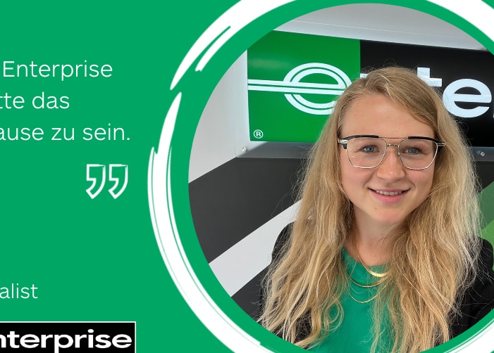 Girl in professional clothes in front of Enterprise sign with a quote on a green background