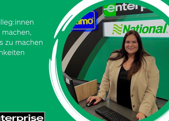 Woman in professional clothes behind Enterprise customer service desk with a quote on a green background