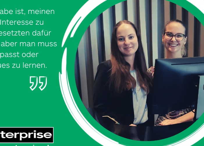 Two female employees with a computer monitor.  Quote on green background