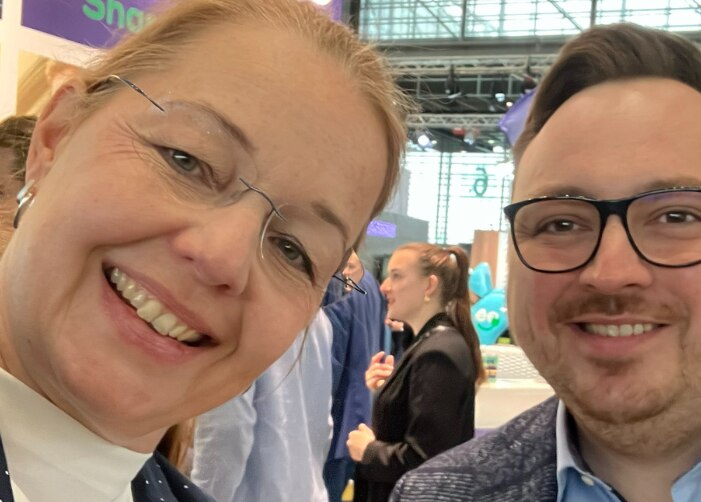 2 Enterprise employees smiling at a convention