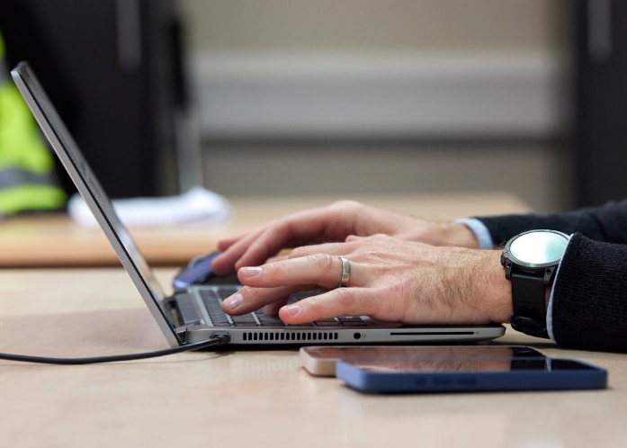 Enterprise Mobility team member on a laptop using chatgpt.