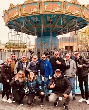 Employees in front of a carnival ride