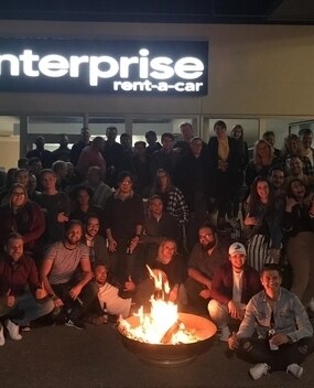 Group of employees with a bonfire