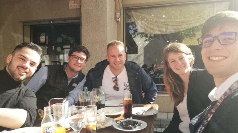 5 people sitting at lunch outside at a table